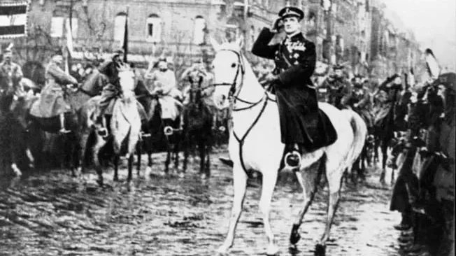 Celebrated war hero Admiral Nicholas Horthy rides his white horse through Budapest, waving to cheering crowds.
